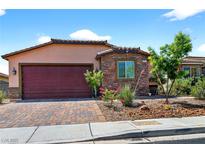Charming single-story home featuring stone accents, a red garage door, and well-maintained landscaping at 2079 Port Royal Dr, Laughlin, NV 89029