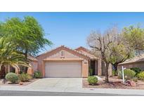 Charming single-story home featuring a well-maintained yard, mature trees, and an attached two-car garage at 2154 Eagle Sticks Dr, Henderson, NV 89012