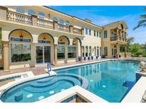 Inviting backyard pool and spa area of a luxury home with mediterranean architecture at 2200 Glenbrook Way, Las Vegas, NV 89117