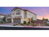 Two-story home featuring a brick driveway, two-car garage, and desert landscaping against a pink and blue sunset at 2833 Sangro Ct, Henderson, NV 89044