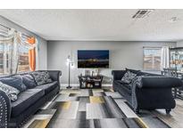 Inviting living room with two comfortable sofas, a large flatscreen TV, and a modern, stylish rug at 2915 Cedar Ave # 11C, Las Vegas, NV 89101