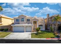 Charming two-story home features a three-car garage, a well manicured lawn, and a beautiful tiled roof at 4654 Stuttgart St, Las Vegas, NV 89147