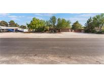 Single story home with desert landscaping and a long driveway on a sunny day at 4905 Ricky Rd, Las Vegas, NV 89130