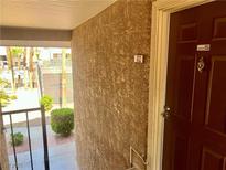 Exterior of a condo entrance showing door, ADT security, and view of community tennis court at 5020 Indian River Dr # 432, Las Vegas, NV 89103