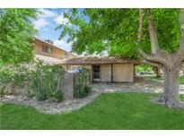 Charming single story home featuring a well-maintained lawn and mature trees at 5083 Village Dr, Las Vegas, NV 89142