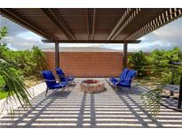 Charming patio featuring a fire pit, modern seating, and a stylish pergola for outdoor relaxation at 5761 E Badlands Ln, Pahrump, NV 89061