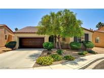 Charming single-story home featuring a well-manicured front yard with lush landscaping and a two-car garage at 6808 Mystic Plain Ct, Las Vegas, NV 89149