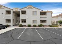 Condo building with assigned parking and manicured landscaping features a bright and pleasing exterior at 855 N Stephanie St # 2415, Henderson, NV 89014