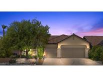 Charming single-story home featuring desert landscaping, a tile roof, and a spacious three-car garage at 9233 Onyx Point Ct, Henderson, NV 89074