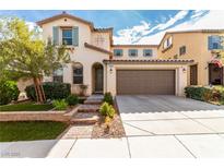 Inviting two-story home featuring a tidy lawn, neutral paint, and two-car garage at , Las Vegas, NV 89166