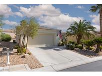 Charming single-story home featuring a two-car garage, desert landscaping and mature palm trees at 10240 Notte Ave, Las Vegas, NV 89135