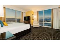 Beautiful bedroom with a king bed, chair, and floor-to-ceiling windows overlooking the city at 2000 Fashion Show Dr # 5022, Las Vegas, NV 89109
