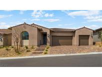 Charming single-story home with a three-car garage and desert landscaping at 346 Tigullio Ave, Henderson, NV 89011