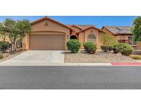 Charming single-story home featuring a desert landscape, a two-car garage, and a welcoming facade at 3544 Tack St, Las Vegas, NV 89122