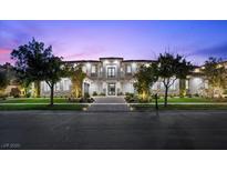Elegant two-story home featuring manicured landscaping and a symmetrical facade at 42 Ravenswood Ave, Las Vegas, NV 89141