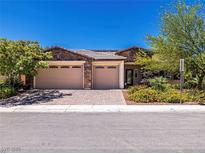 Charming single-story home featuring stone accents, a three-car garage, and well-maintained landscaping at 5170 Agio Ave, Pahrump, NV 89061