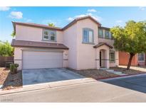 Two-story home featuring a two-car garage and a well-maintained front yard with desert landscaping at 5340 Santa Fe Heights St, North Las Vegas, NV 89081