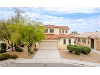 Two-story home featuring a neutral color scheme, red tile roof, and well-manicured landscaping at 5526 Spruce Hill Ct, Las Vegas, NV 89148