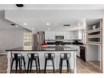 Bright kitchen features a large island with bar seating and stainless steel appliances at 5905 Paseo Montana, Las Vegas, NV 89108
