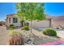 Charming single-story home featuring a well-manicured front yard and a welcoming two-car garage at 6656 Arctic Breeze St, North Las Vegas, NV 89084
