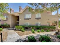 Inviting condo exterior with manicured landscaping and stairway access to the upper units at 700 Capri Dr # 27B, Boulder City, NV 89005