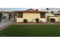 Exterior view of home showing landscaped yard, and carport at 706 Red Lake Way, Las Vegas, NV 89110