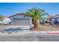 Charming single-story home with a xeriscaped front yard and mature palm tree enhancing its curb appeal at 7405 Saybrook Point Dr, Las Vegas, NV 89128