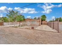 Charming single-story home with a white fence and drought resistant landscaping in the front yard at 75 N 27Th St, Las Vegas, NV 89101