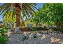 Charming single-story home with desert landscaping, mature trees, and a welcoming curb appeal at 1115 Melville Dr, Las Vegas, NV 89102