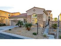 Charming stone-accented home featuring a desert landscaped front yard and attached two-car garage at 1223 Casa Palermo Circle Cir, Henderson, NV 89011