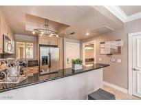 Bright kitchen features stainless steel appliances, a breakfast bar, and ample cabinet space at 230 E Flamingo Rd # 203, Las Vegas, NV 89169