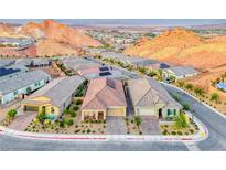 Scenic street view showcasing homes with desert landscaping and mountain views in a vibrant community at 32 Tatahatso Point St, Henderson, NV 89011