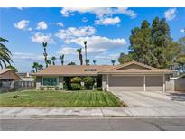 Charming single-story home with well-manicured lawn and a spacious two-car garage at 3361 Iberia St, Las Vegas, NV 89146