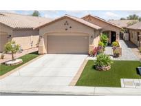 Charming single-story home featuring desert landscaping, a two-car garage, and a welcoming front entryway at 6114 Saddle Horse Ave, Las Vegas, NV 89122