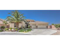 Beautiful single-story home with a well-manicured lawn, mature palm tree, and a three-car garage at 6821 Sleepy Pine St, Las Vegas, NV 89130