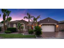 Charming single-story home featuring stone accents, a two-car garage, and well-manicured landscaping at 8209 Chapelle Ct, Las Vegas, NV 89131