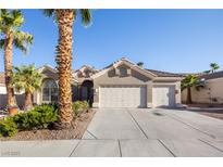 Charming single-story home with a three-car garage, desert landscaping, and majestic palm trees at 8537 Highland View Ave, Las Vegas, NV 89145