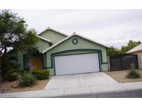Charming single-story home with a two-car garage, landscaped front yard, and desert landscaping at , Las Vegas, NV 89130