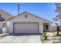 Charming single-story home with a two-car garage and low maintenance landscaping in a suburban neighborhood at 1320 Rainbow Meadows Dr, Las Vegas, NV 89128