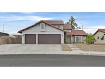 Charming two-story home featuring a red tile roof, double garage, and landscaped front yard at 1517 Kirby Dr, Las Vegas, NV 89117