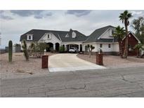 Stately home featuring a brick-lined driveway leading to a portico entrance and a well-manicured, xeriscaped front yard at 156 N Parawan St, Henderson, NV 89015