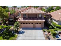 Two-story home featuring a tile roof, three-car garage, and meticulously landscaped front yard at 2208 Fiero Dr, Las Vegas, NV 89134