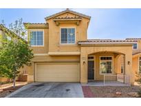 Inviting two-story home featuring a two-car garage and covered front porch at 2621 Rainbow Glow St, North Las Vegas, NV 89030