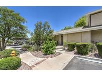 Inviting front entrance with lush landscaping and a covered parking area, perfect for easy access at 2761 Carnation Ln # 1, Henderson, NV 89074