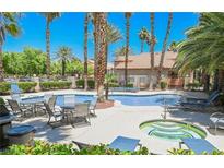 Resort-style pool and spa area surrounded by lush landscaping and comfortable seating for relaxation at 2925 Wigwam Pkwy # 123, Henderson, NV 89074