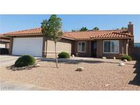 Charming home features a low-maintenance front yard, red tile roof, and two-car garage at 391 Newbury Ct, Henderson, NV 89015