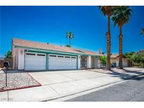 Charming single-story home featuring a two-car garage, mature landscaping, and blue skies in a quiet neighborhood at 4774 Walteta Way, Las Vegas, NV 89119