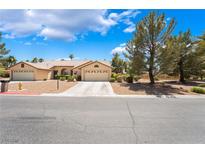 Charming single-story home with a well-maintained front yard and attached two-car garage at 4909 Desert Poppy Dr, Las Vegas, NV 89130
