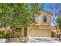 Charming two-story home with a well-maintained lawn and a two-car garage in a residential neighborhood at 5021 Ropers Rock Ct, Las Vegas, NV 89131