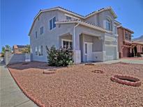 Charming two-story home featuring a xeriscaped front yard with desert landscaping and lovely curb appeal at 6042 Thorne Bay Ct, Las Vegas, NV 89110